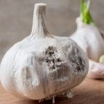 Why does garlic rot during storage?